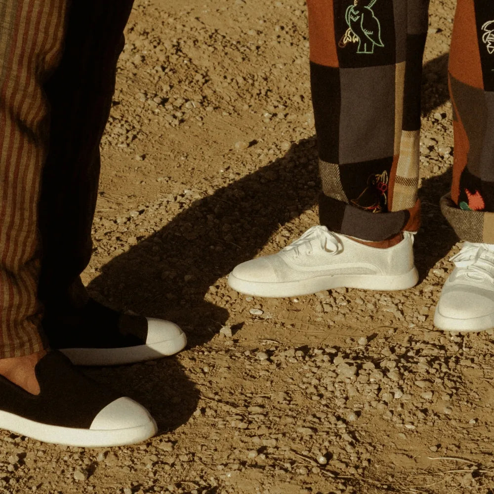 Friends standing in Juntos White Lace-up and Black Slip-on