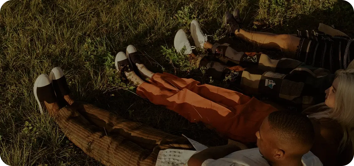 people laying on a grassy surface