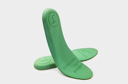 Green shoe insoles on a white background