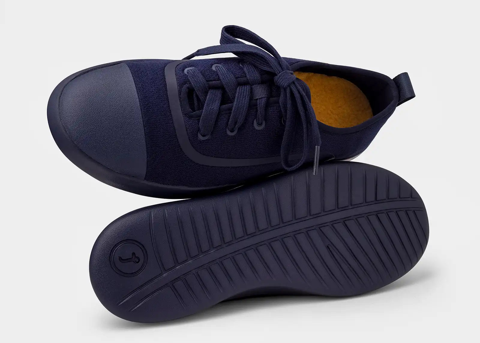Navy blue sneakers with a white background