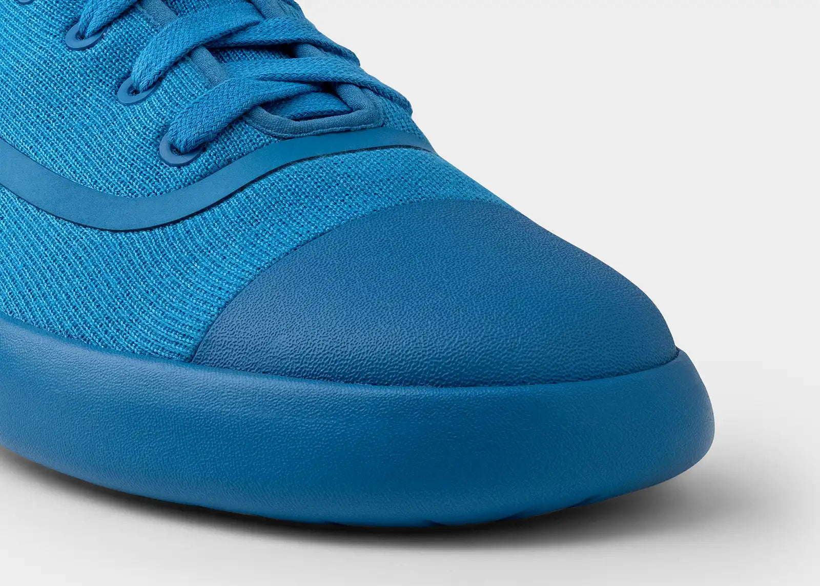 Close-up of a blue sneaker on a light gray background