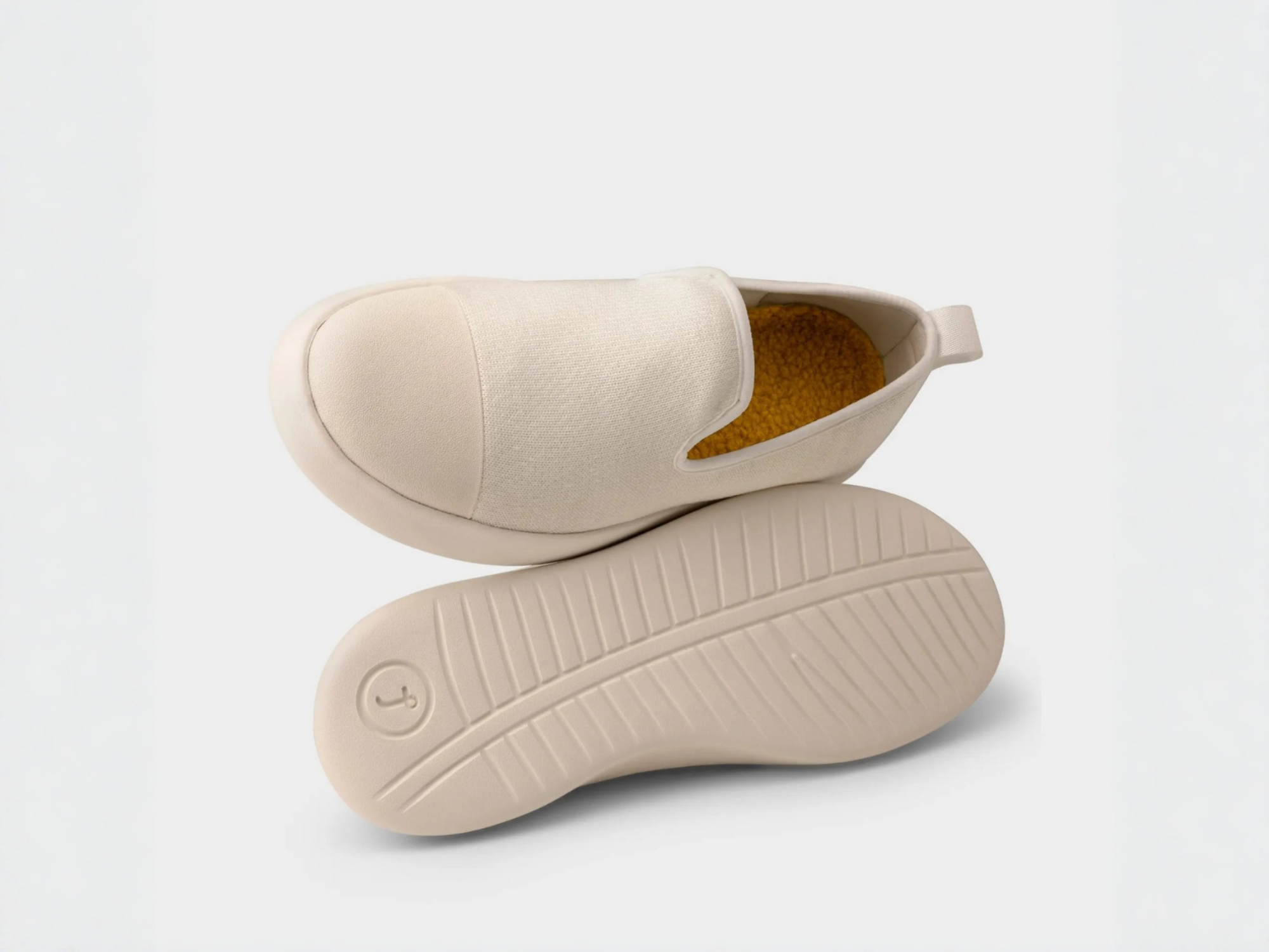 AlpaKnit Slip-On Off white shoes with a focus on the sole on a light gray background