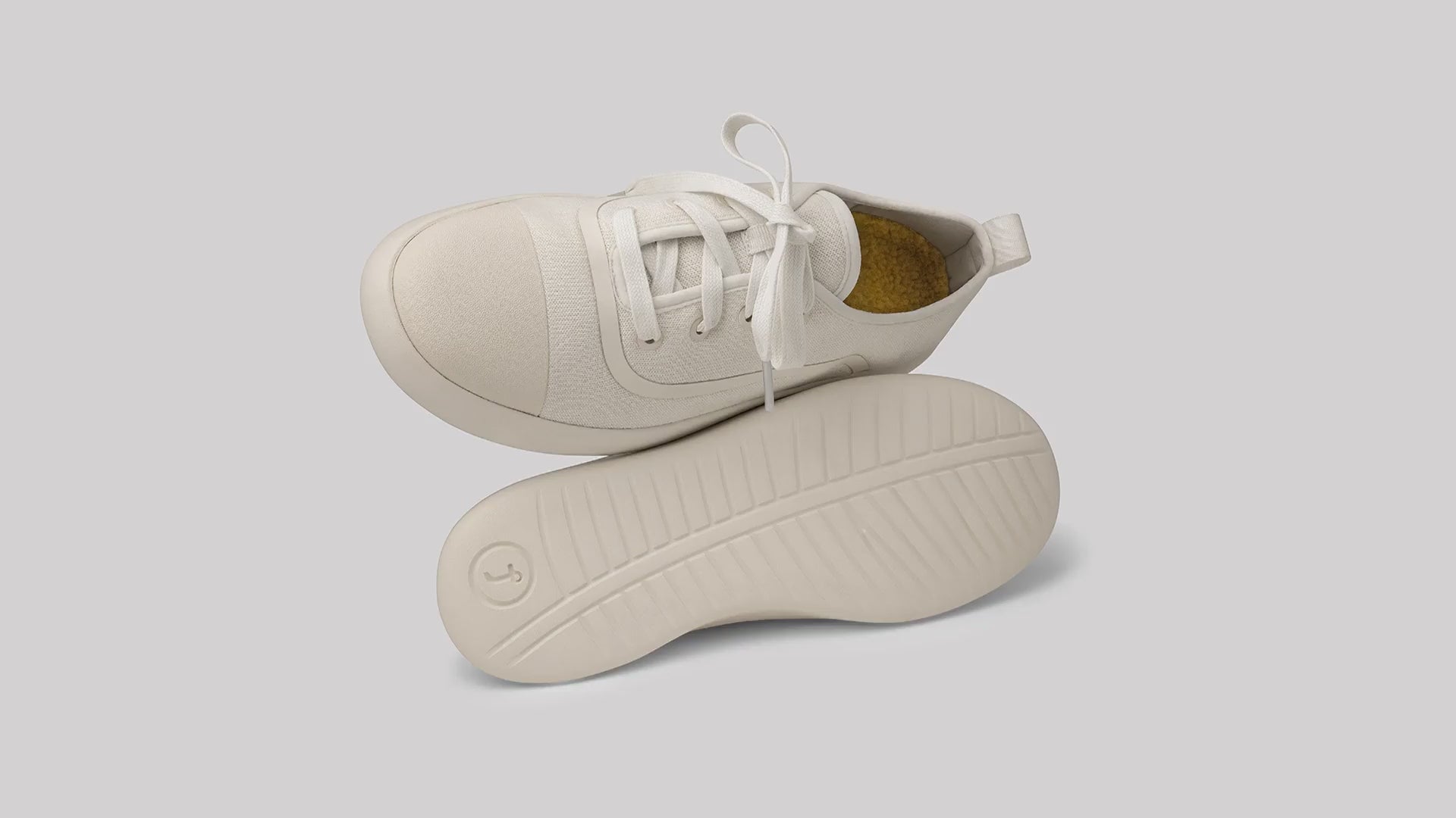 An add of juntos AlpaKnit Lace-Up and slip-on on a green land