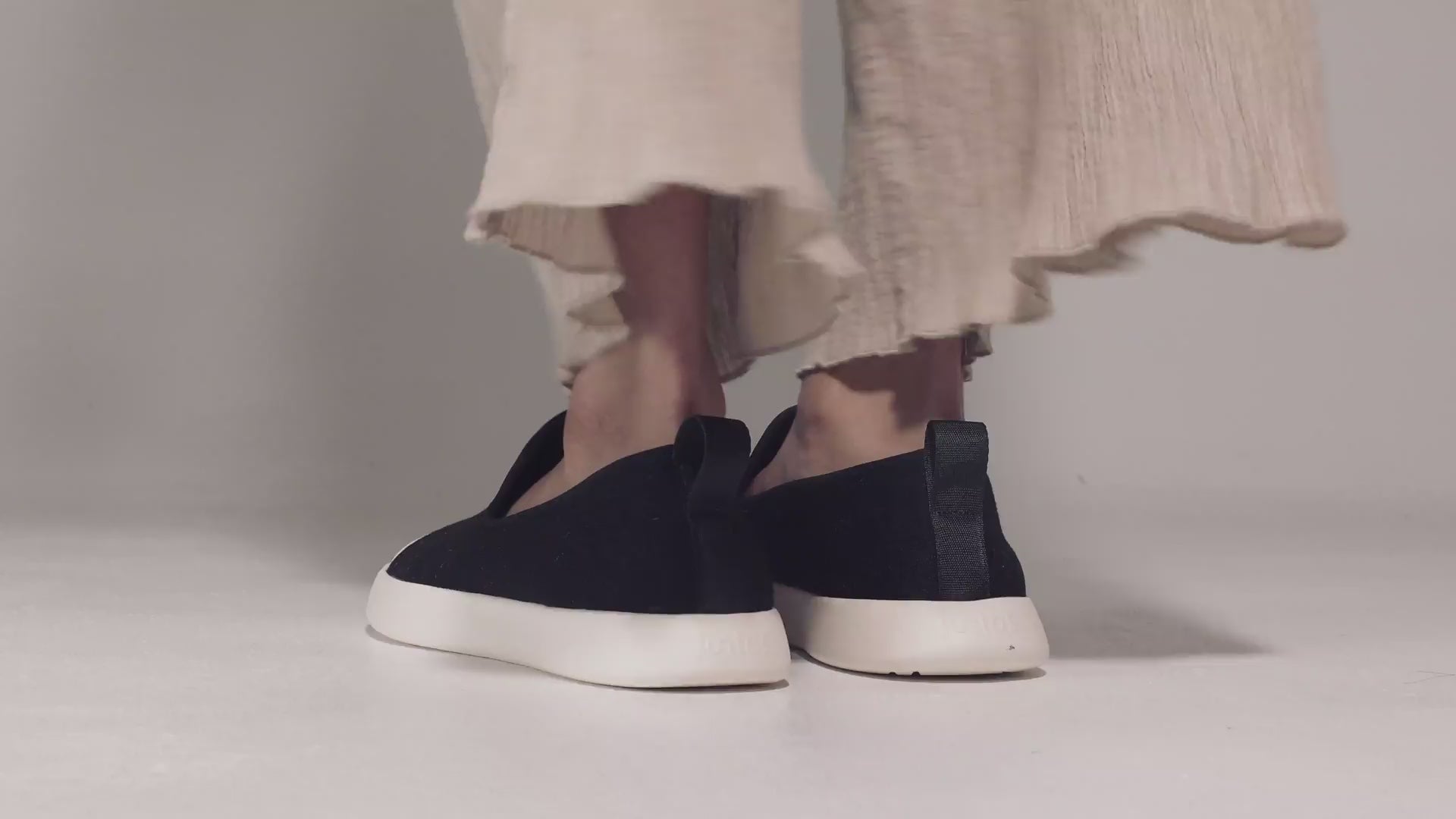 Women wearing  slip-on shoes on white surface