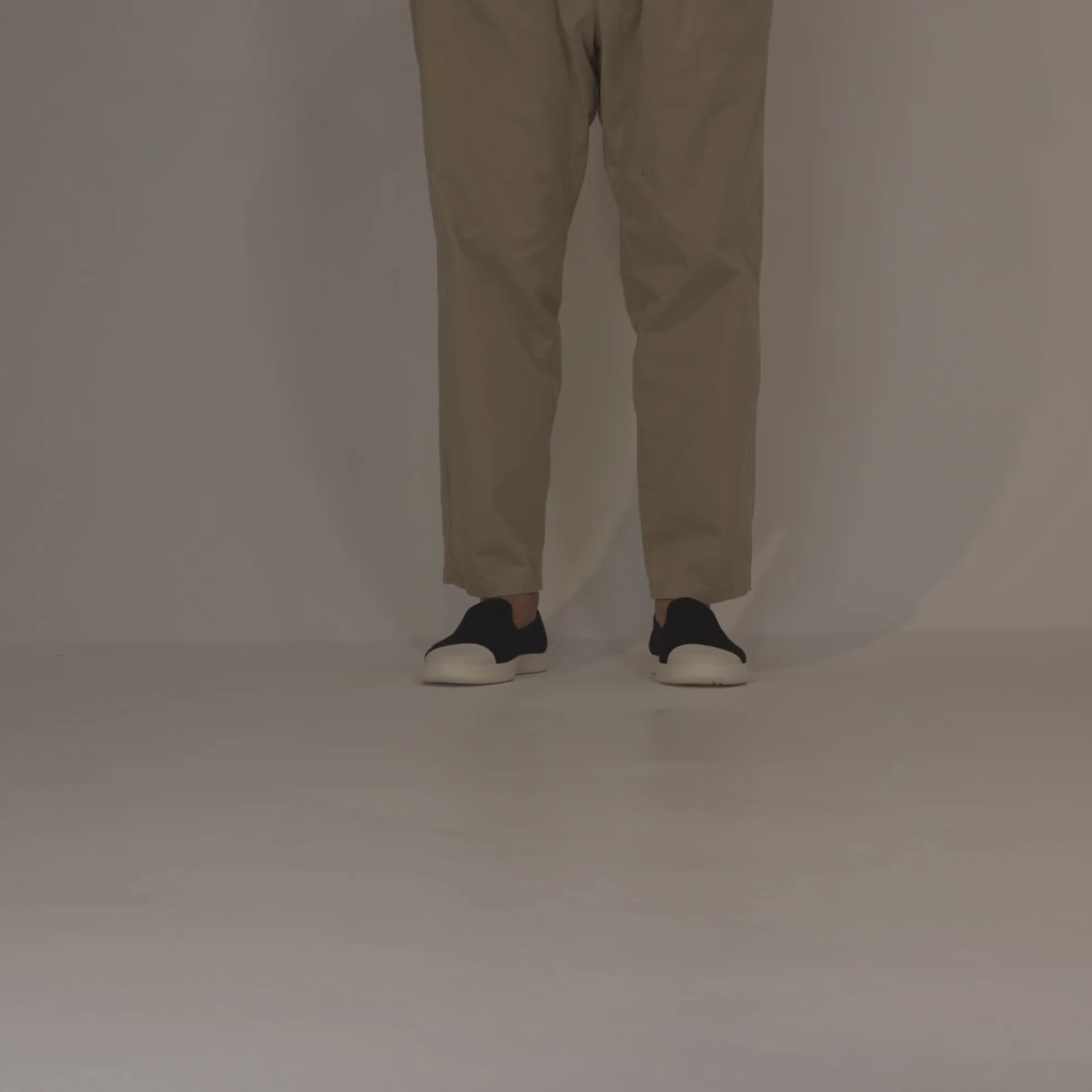 Man walking forward in Juntos Black Slip Ons