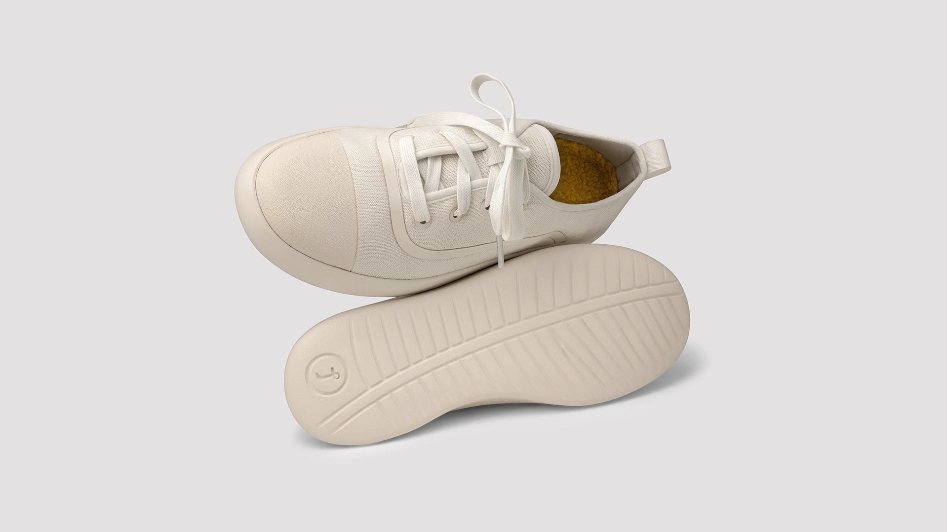 An add of juntos AlpaKnit Lace-Up and slip-on on a green land